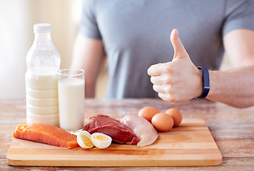 Image showing man with food  rich in protein showing thumbs up