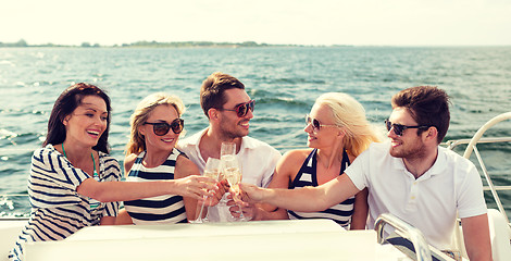 Image showing smiling friends with glasses of champagne on yacht