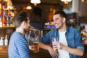 Image showing happy male friends drinking beer at bar or pub