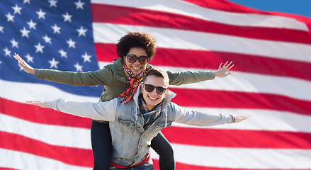Image showing happy multiracial couple over american flag