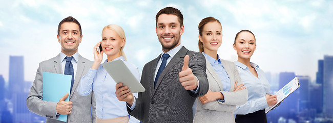 Image showing group of smiling businessmen showing thumbs up