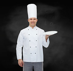 Image showing happy male chef cook showing empty plate