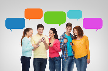 Image showing group of smiling teenagers with smartphones