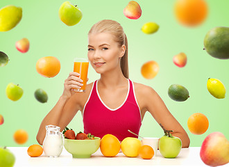 Image showing happy woman holding glass of orange juice