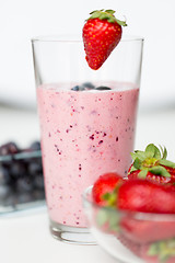 Image showing close up of milkshake decorated with strawberry