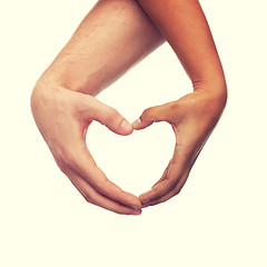 Image showing woman and man hands showing heart shape