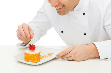 Image showing close up of male chef cook decorating dessert