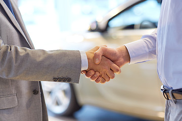 Image showing close up of male handshake in auto show or salon