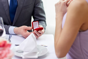 Image showing excited young woman and boyfriend giving her ring