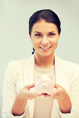 Image showing lovely woman with piggy bank