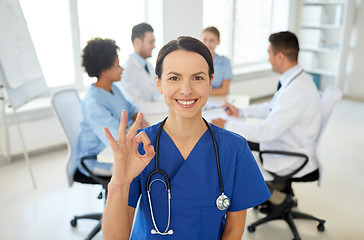 Image showing happy doctor over group of medics at hospital