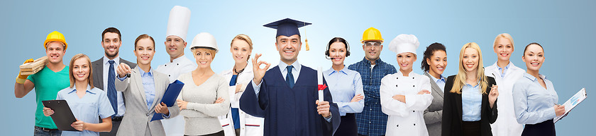 Image showing happy bachelor with diploma over professionals