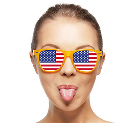 Image showing happy teenage girl in shades with american flag