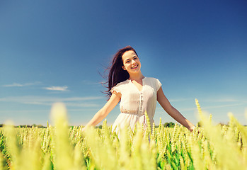 Image showing smiling young woman on cereal field