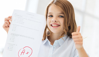 Image showing smiling little student girl with test and A grade