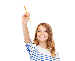 Image showing cute little girl drawing with brush in the air