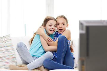 Image showing scared little girls watching horror on tv at home