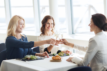 Image showing happy women drinking champagne at restaurant