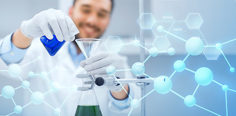 Image showing close up of scientist with test tubes and funnel