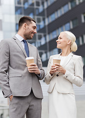 Image showing smiling businessmen with paper cups outdoors