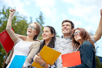 Image showing group of happy students showing triumph gesture