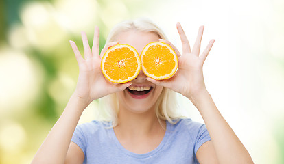 Image showing happy woman having fun covering eyes with orange