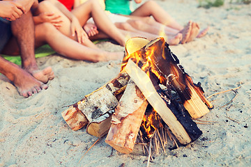 Image showing close up of friends sitting on summer beach