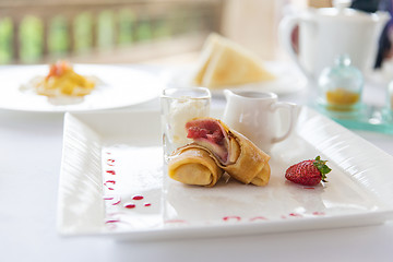 Image showing close up of pancakes and honey or jam on plate