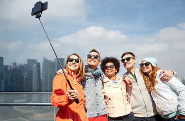 Image showing smiling friends taking selfie with smartphone