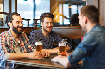 Image showing happy male friends drinking beer at bar or pub