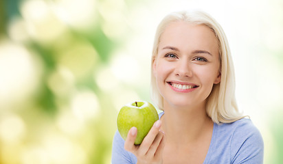 Image showing happy woman eating green apple