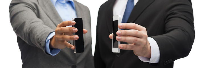 Image showing businessman and businesswoman with smartphones