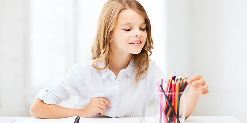 Image showing girl drawing with pencils at school