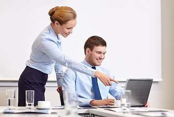 Image showing businessman and secretary with laptop in office