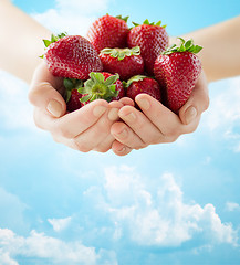 Image showing close up of woman hands holding strawberries