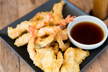 Image showing close up of deep-fried shrimps and soy sauce