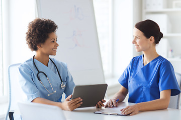 Image showing happy doctors with tablet pc meeting at hospital