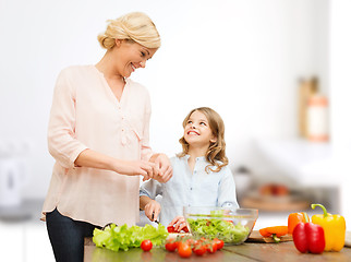 Image showing happy family cooking vegetable salad for dinner