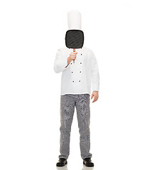 Image showing male chef cook covering face with grill pan