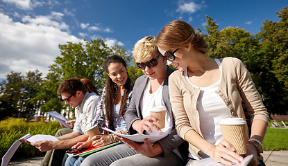 Image showing group of happy students with notebooks and coffee