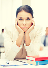 Image showing stressed businesswoman in office