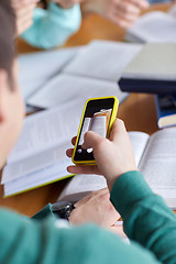 Image showing student hands with smartphone making cheat sheet