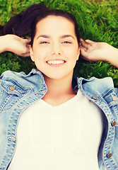 Image showing smiling young girl lying on grass