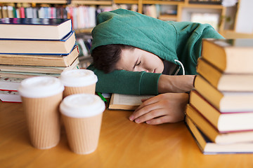 Image showing tired student or man with books in library