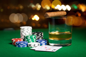 Image showing close up of chips, cards whisky and cigar on table