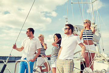 Image showing smiling friends sailing on yacht