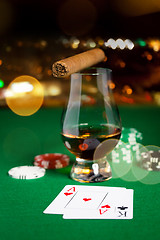 Image showing close up of chips, cards whisky and cigar on table