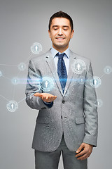 Image showing happy businessman in suit showing network contacts