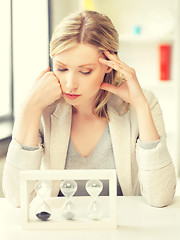 Image showing pensive businesswoman with sand glass