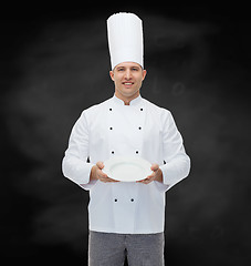 Image showing happy male chef cook showing empty plate